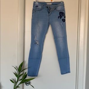 Worn embroidered jeans